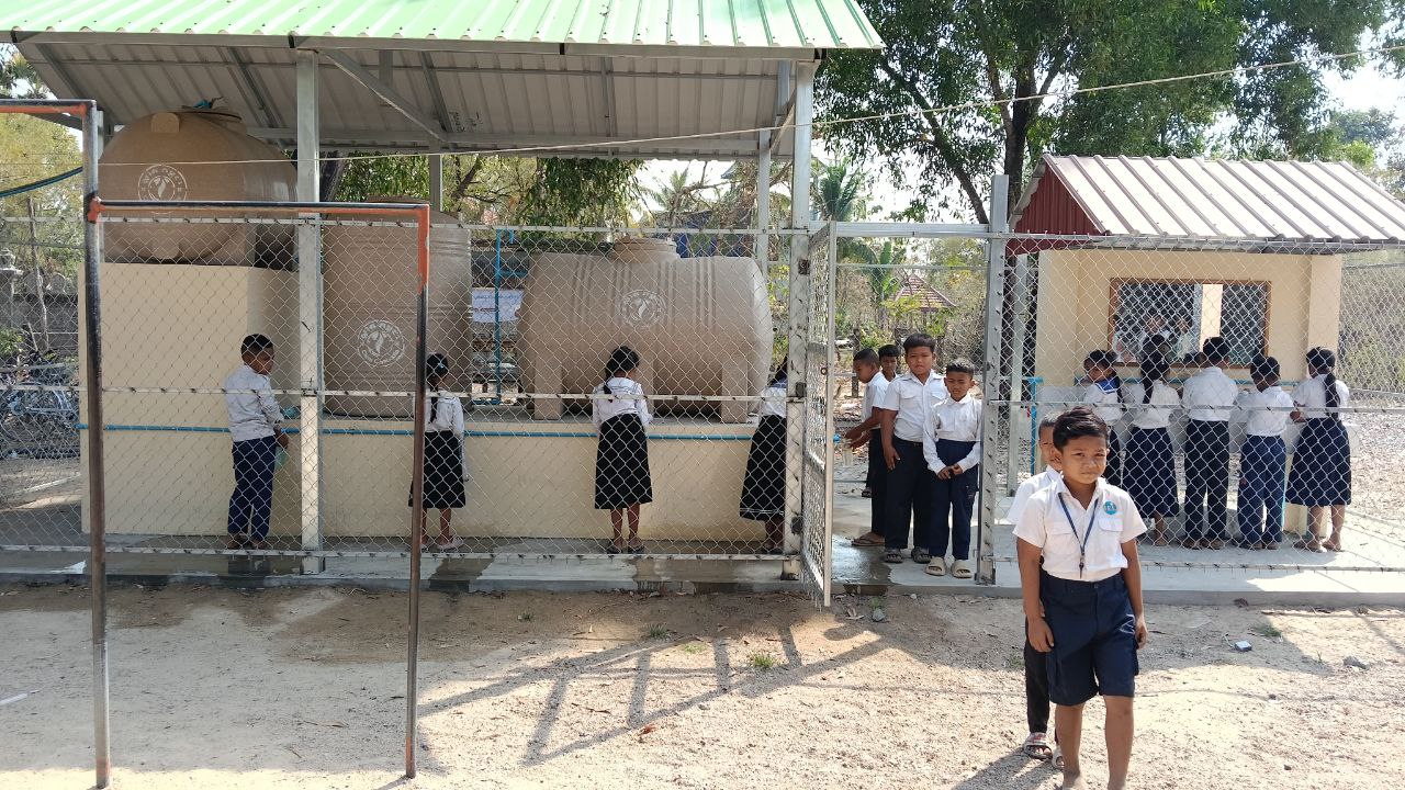 Students collecting safe drinking water at a sBSF water station &mdash; reference image from a previous WASH project