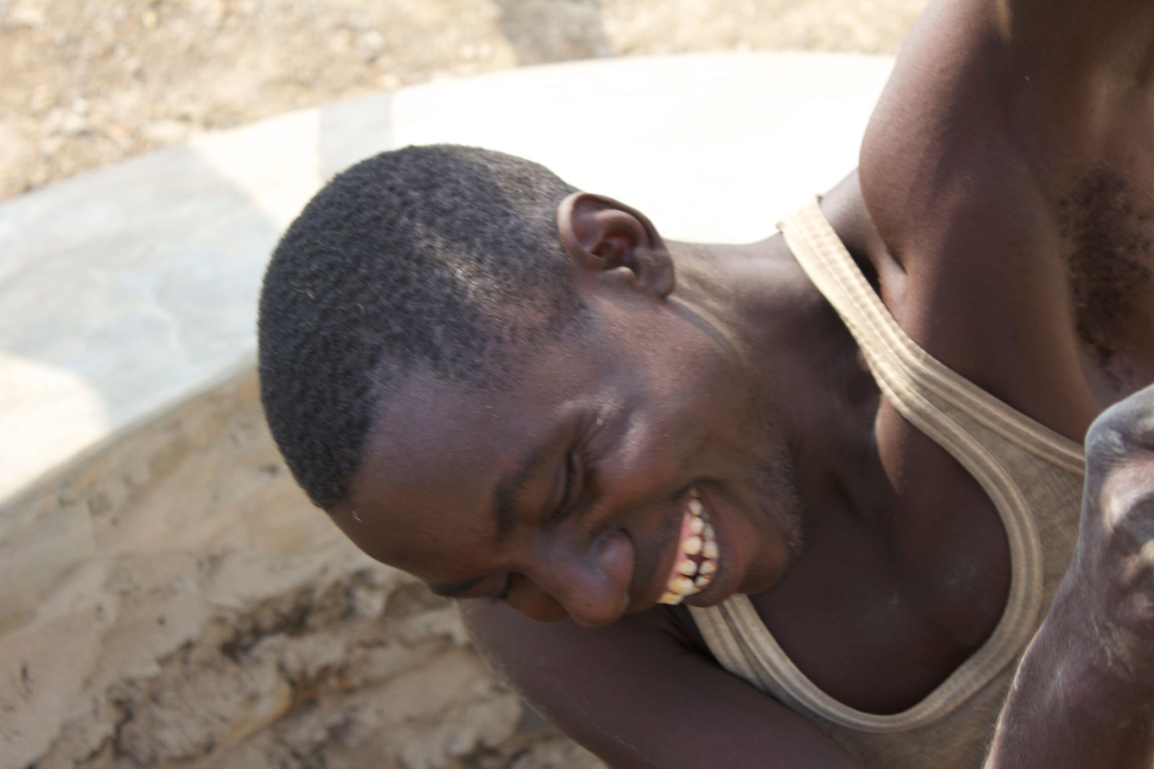 Worker inside the hand-dug shaft, on the rope